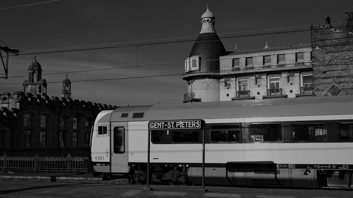Black and white photo of Gent-St. Pieters train at historic station in Ghent, Belgium.