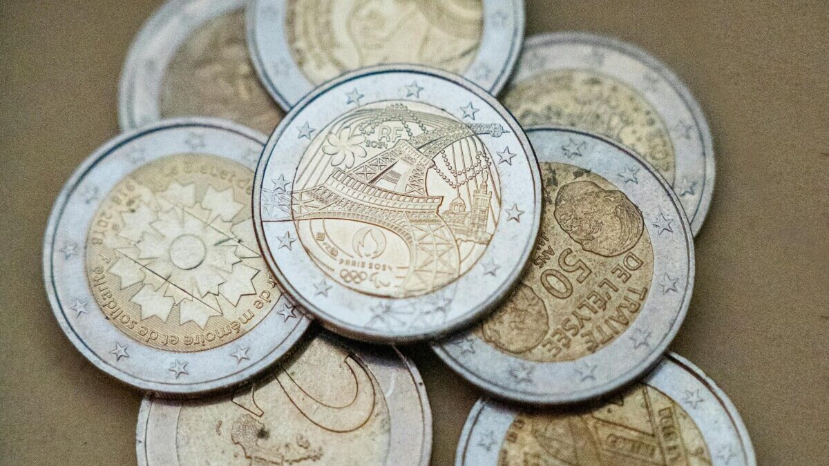 Detailed view of euro coins with a focus on the Eiffel Tower design, symbolizing Paris and France.